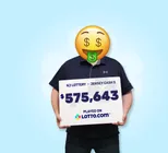 Winner Josef holds a check for $575,643 in his hands